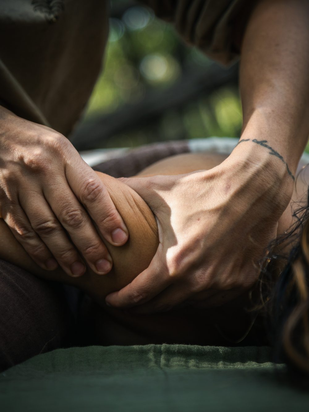 Hands working along a shoulder during a treatment
