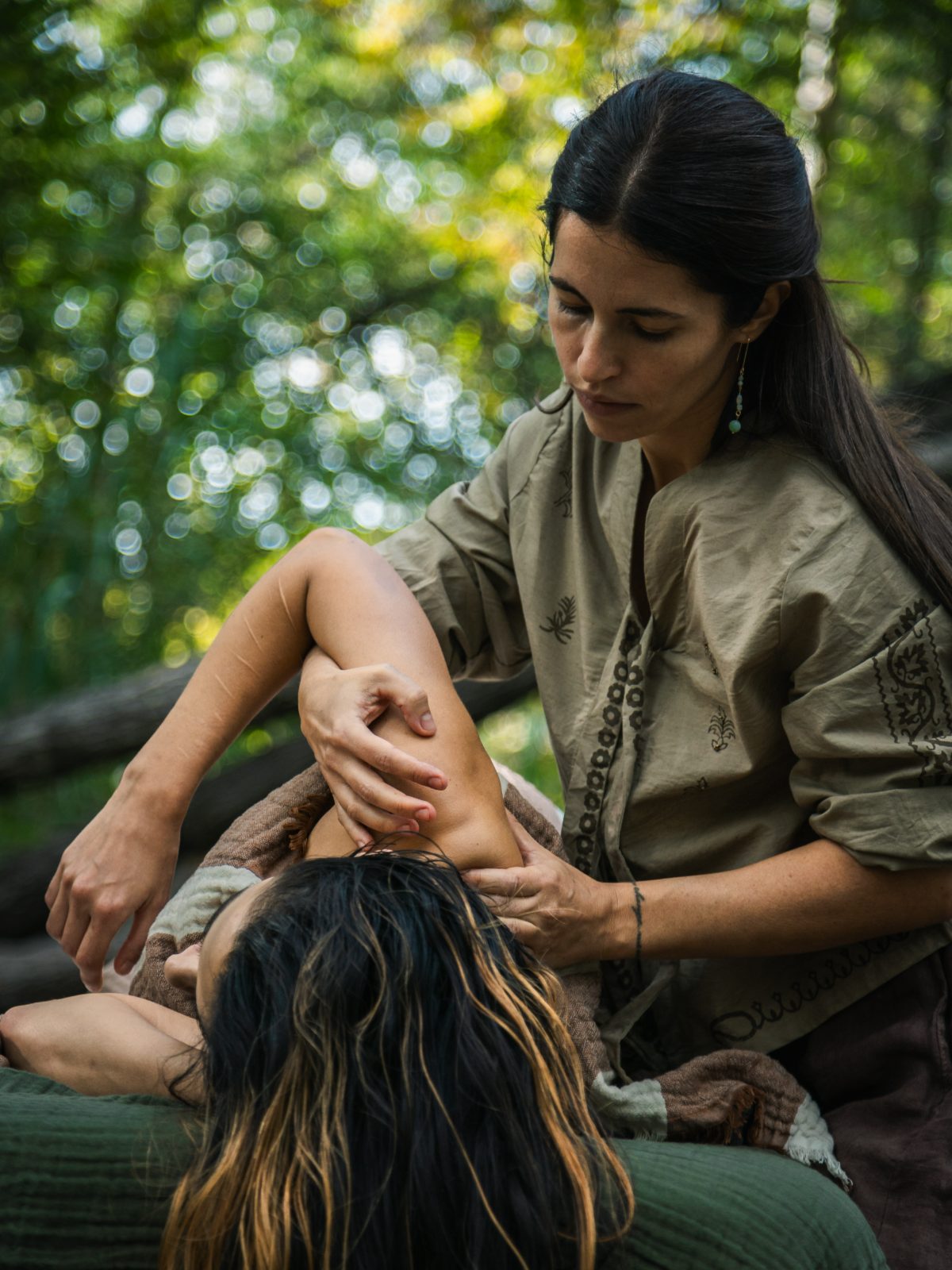 Natalie giving a treatment beside a forest stream